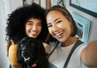 Happy, selfie and portrait of lesbian couple with dog in modern apartment bonding together. Love, smile and interracial young lgbtq women taking a picture and holding animal pet puppy at home.