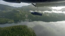 Camera Beneath Flying Air Plane Over Rain Forest - Canada