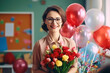Portrait of a happy smiling satisfied teacher woman with a bouquet of flowers and helium balloons in the classroom during celebrating world teachers day