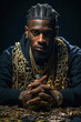 Portrait of an African American rapper with gold chains around his neck.