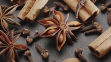 Lots Of Three Spices For Mulled Wine – Star Anise, Cinnamon And Clove Slowly Scroll Clockwise, Macro Video Footage. A Great Background For Your Projects.