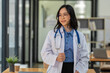 © crizzystudio - medical staff Asian female doctor smiles enthusiastically Doctors are experts, have knowledge, are good at studying, analyzing, and planning treatment for patients. Treatment and medicine concept