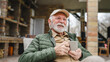 © Miljan Živković - One senior man sit outdoor in autumn day hold cup of coffee or tea
