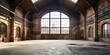 Empty large and old factory building with large windows and sunrays