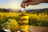 In hand, a bottle of rapeseed oil, the essence of culinary delight