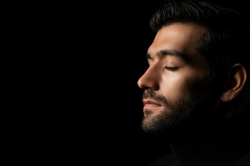 close up face caucasian handsome man isolated on black background handsome man close eyes in studio 