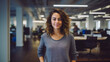 © Stock'd  - portrait of creative woman at work wearing a gray tshirt and jeans smiling to camera in casual office