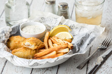 A Close Up Of A Serving Of Fresh Fish And Chips Ready For Eating.