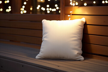 Wall Mural - Square white pillow on the wooden bench background with bokeh Christmas lights for mockups. Cozy winter aesthetic.