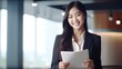 © WS Studio 1985 - portrait of a smiling asian businesswoman holding white paper d on white background