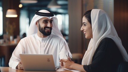 Poster - a guy and a lady dressed traditionally work in a dubai business office. portraits of prominent entre