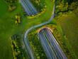 Aerial view of a green overpass over an empty highway during sunset.