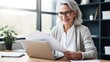 © WS Studio 1985 - Senior Business Woman working on laptop computer. generative ai