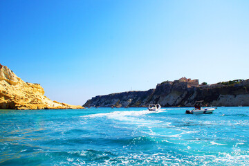 Wall Mural - Incredible view from Tremiti Islands (Isole Tremiti) at the foaming surface of the blue Adriatic Sea crossed by different motorboats with views of rocky spurs replete with vegetation in the background