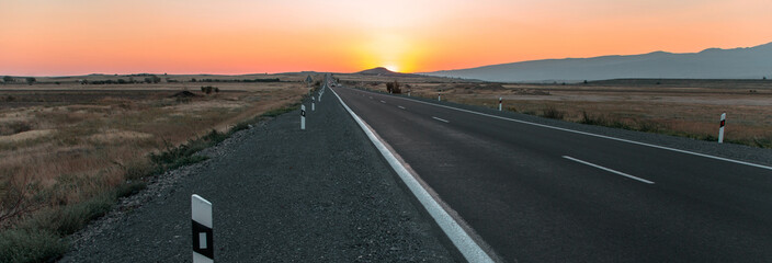 Wall Mural - asphalt road with sunset