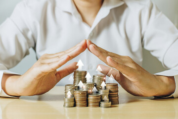 Wall Mural - A man hands covering coins stacks with white up arrow. Money coins for financial, business growth concept. Investment and saving concept