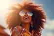 Portrait of beautiful african american woman smiling and looking away. Outdoor portrait of a smiling black lady. Happy cheerful girl with curly black hair laughing