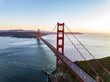 Aerial view of Golden Gate Bridge spanning watercourse. Long suspension bridge and vehicles passing over sea bay. San Francisco, California, USA