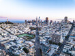 Aerial view of urban borough and downtown with high rise office skyscrapers in background. San Francisco, California, USA