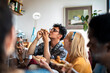 © Marko Geber - Young and diverse group of friends having a pizza party at home