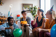 © Marko Geber - Young and diverse group of friends celebrating a birthday at home