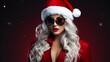 Female Santa Claus. Beautiful sexy girl wearing santa claus clothes and sunglasses.