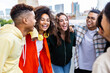 © Xavier Lorenzo - Young group of happy students hugging each other laughing together outside. College diverse friends laughing enjoying lifestyle moment standing in city street. Youth community and friendship concept.