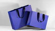 Blue paper shopping bags mockup with black handles
