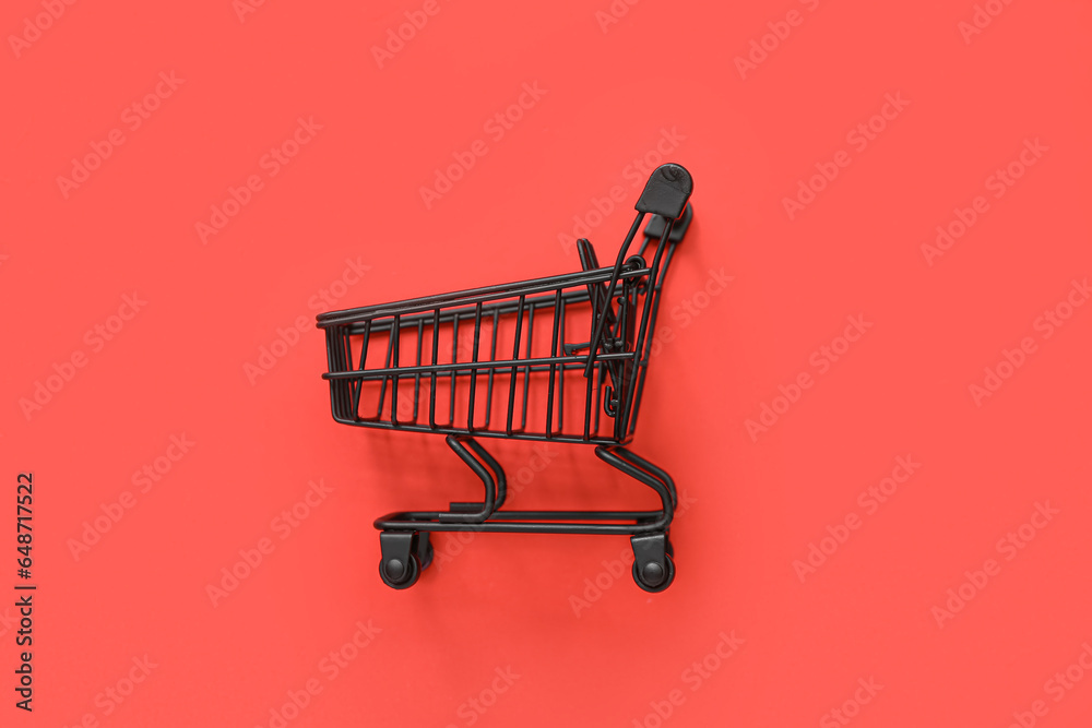 Small shopping cart on red background