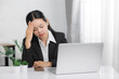 © Keopaserth - Young Asian woman feeling tired suffering using computer working work place. concept global economic, health problems. sad depression serious people from work.