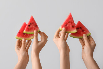 Wall Mural - Female hands with slices of ripe watermelon on white background