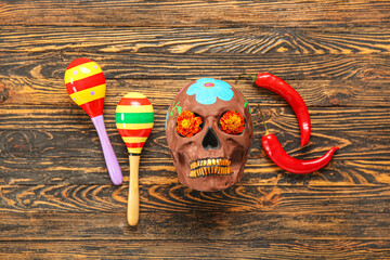 Wall Mural - Mexican maracas with painted skull and chili peppers for Independence Day on wooden background