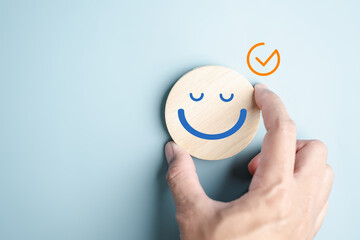 Wall Mural - Hands holding blue happy smile face. mental health positive check up and growth mindset, mental health care recovery to happiness emotion.