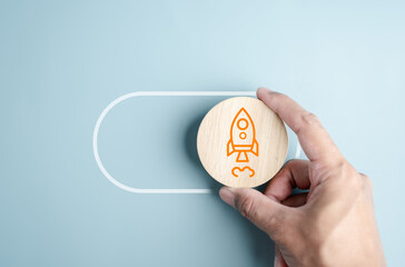 Leinwandbilder - Hand holding switching for start rocket ship launch button to leadership and start business to goal achievement.