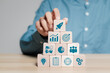 © Pakin - Startup business concept. Businessman arranges wooden blocks with business start-up icons, Starting a business quickly with rocket icon. Business financial growth analysis technology.
