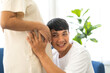 © Art_Photo - Romantic sweet asian couple husband hugging and smiling beauty asian pregnant wife.Man expecting with woman pregnancy hold and kiss to baby in belly at home