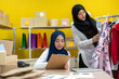 © Art_Photo - Muslim two asian woman freelancer sme business online shopping working and checklist order with cardboard box on table at home - Business online shipping and delivery concept
