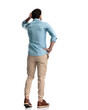 back view of confused young man scratching head and thinking
