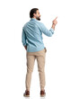 © Viorel Sima - attractive bearded man with hand in pocket pointing finger to side