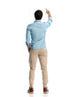 © Viorel Sima - back view of young man in denim shirt pointing finger and holding hand in pocket
