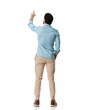 rear view of young man with one hand in pocket pointing finger to the sky