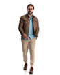 © Viorel Sima - handsome young guy with glasses smiling and walking with hand in pocket