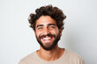 advertising portrait of smiling attractive young man with white teeth. Friendly expression. Spanish features. About 25 years old. Blurred background.