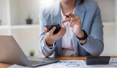 Wall Mural - Close up mobile phone attractive Asian business woman using smartphone Space for text design online business woman working with mobile phone