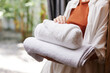 © SHOTPRIME STUDIO - Woman towel closeup laundry stacked person service holding clean female hotel