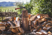 Pile Of Chopped Birch And Pine Fire Wood Around The Chopping Block With Modern Style Heavy Axe. Traditional Autumn Preparation Of Firewood For Heating Of Willage Cottage In Czech Republic Countryside.