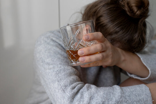 alcoholism, alcohol addiction . drunk woman or female alcoholic drinking whiskey at home. Loneliness and stress. Female alcoholism. 