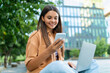 © Prostock-studio - Happy young lady freenlancer working at park, using gadgets