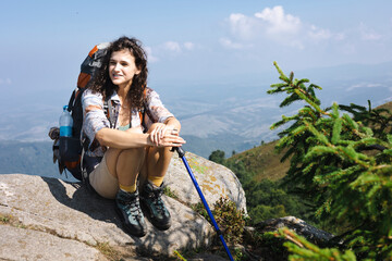 Wall Mural - girl tourist on the background of a mountain landscape