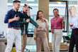 © Mediteraneo - Group of professional people singing karaoke in the modern office